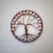Handmade wire-wrapped tree of life home decor featuring twisted wire branches with wooden and pearl-like beads, framed in brown green yarn